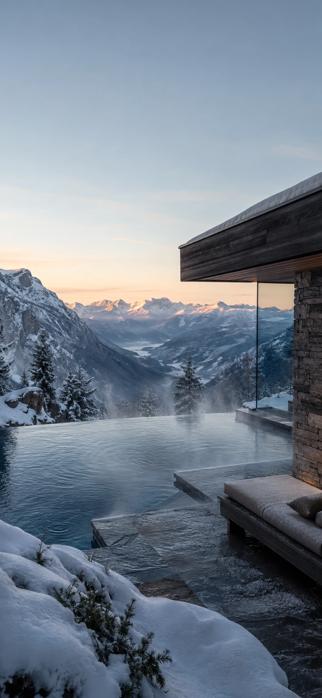 Mountain infinity pool overlooking snowy peaks at sunrise